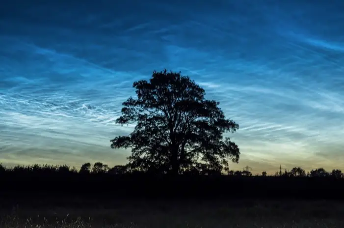 man photographs clouds