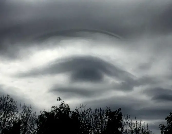 man photographs clouds